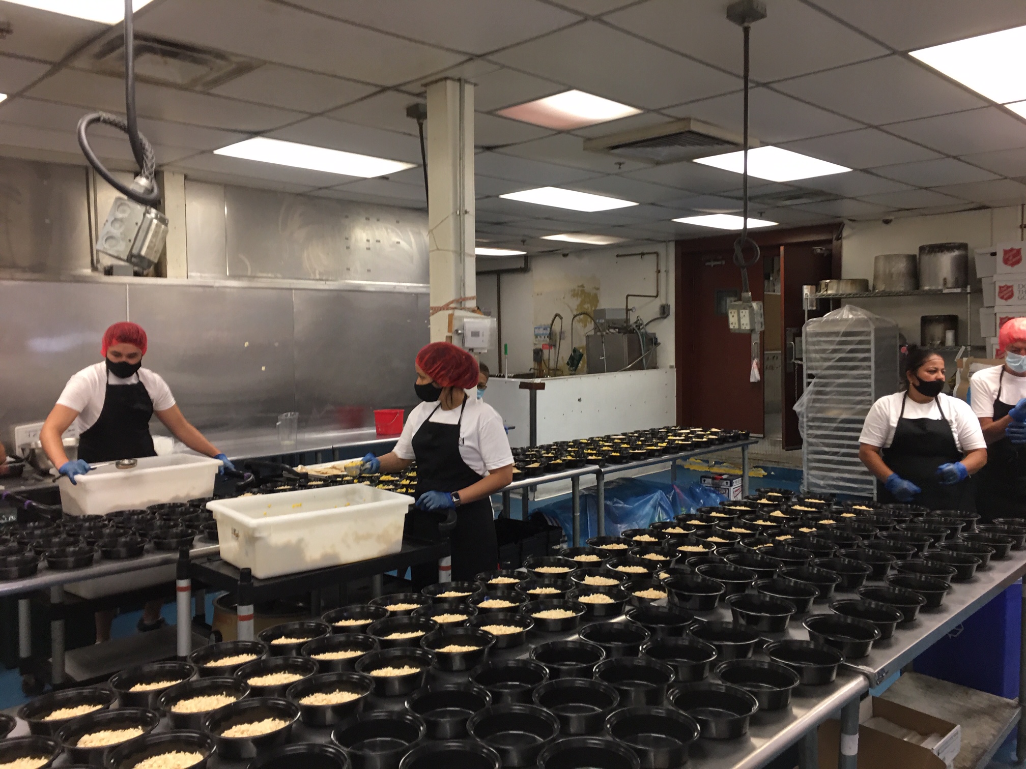 Chefs working on prep line in shared kitchen